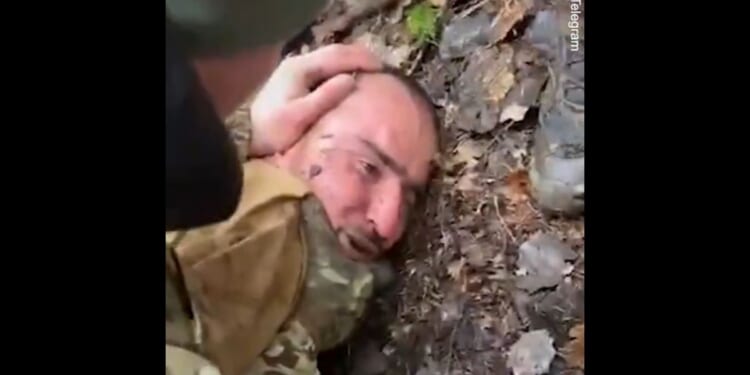 Russian prisoner Saidakrami Rachabalizoda, a suspect in the March 22 terrorist attack, is beaten by soldiers.