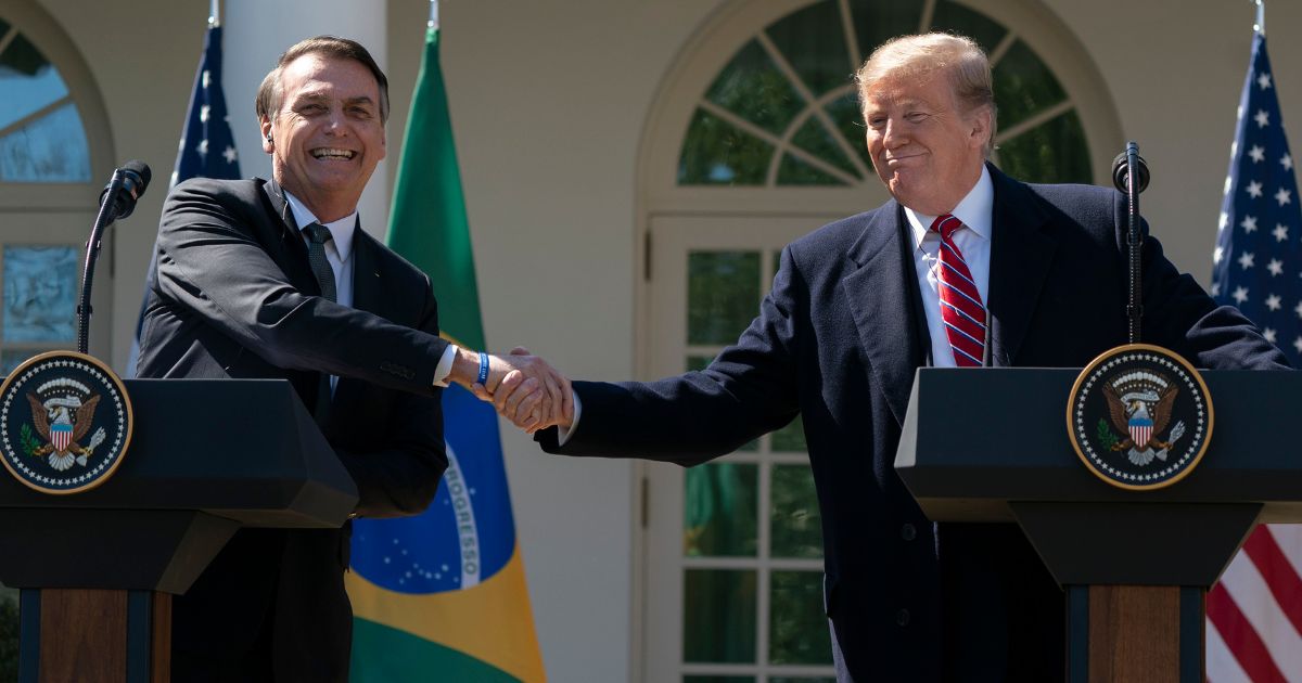 Then-President Donald Trump and Then-Brazilian President Jair Bolsonaro shake hands during a joint news conference in the Rose Garden at the White House in Washington on March 19, 2019.