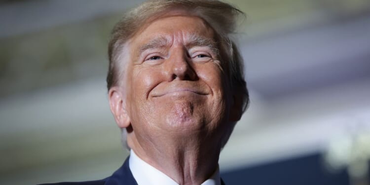 Former President Donald Trump smiles at supporters after speaking at a Get Out The Vote rally in North Charleston, South Carolina, on Feb. 14.