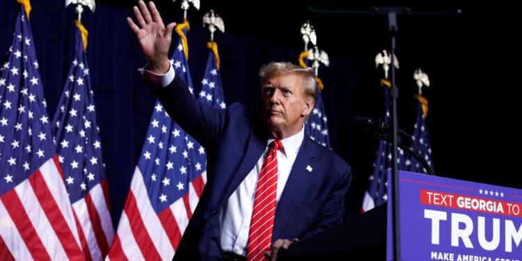 Former President Donald Trump leaves the stage at the conclusion of a campaign rally on March 9 in Rome, Georgia.