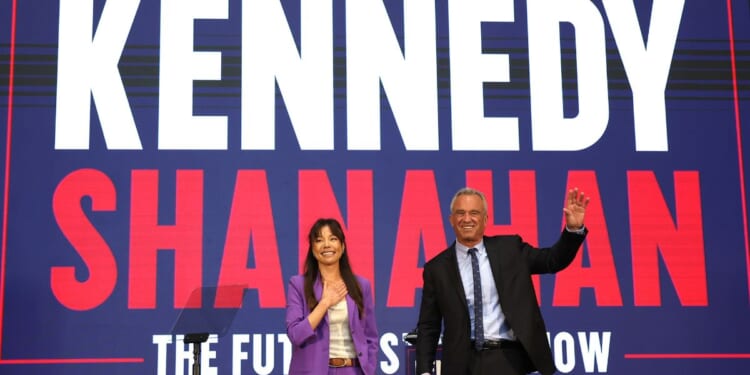 Independent presidential candidate Robert F. Kennedy Jr. and his vice presidential pick Nicole Shanahan take the stage during a campaign event on Tuesday in Oakland, California.