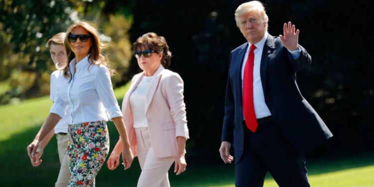 President Donald Trump, right, waves as he walks out, with from l-r., son Barron, first lady Melania Trump, and Amalija Knavs, mother of first lady Melania Trump, as they walk across the South Lawn of the White House in Washington, June 29, 2018.