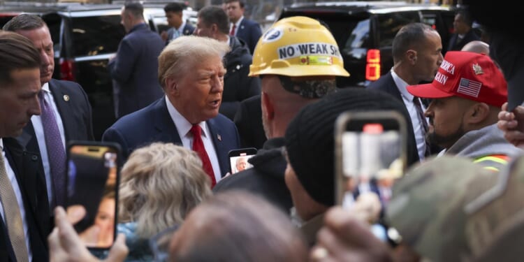 Court-bound Donald Trump gets warm, raucous reception at Manhattan construction site