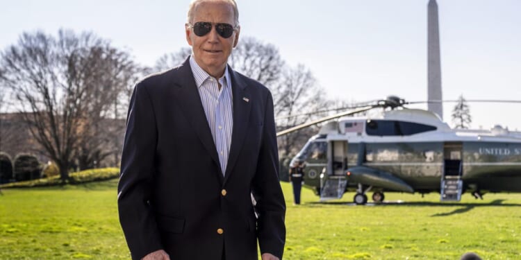 Biden's aides flank him to Marine One to block cameras from catching him shuffling