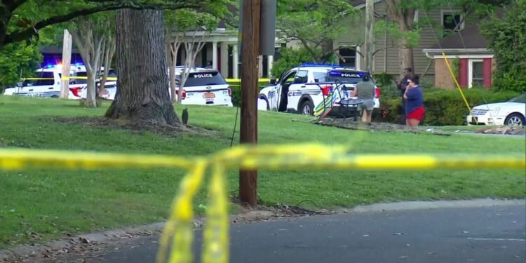 police cars outside the home where four law enforcement officers were shot and killed