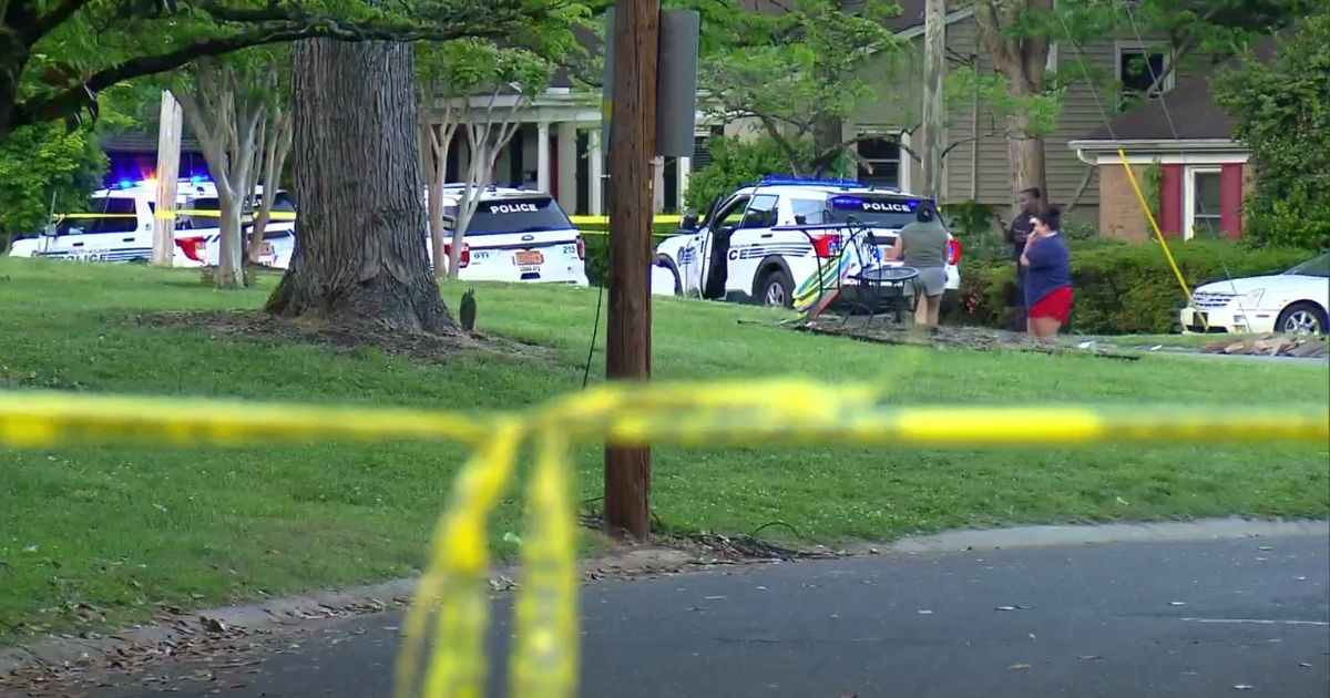 police cars outside the home where four law enforcement officers were shot and killed