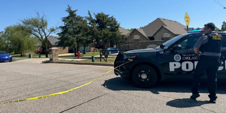 Oklahoma City police at the scene of a home where the bodies of five, including two children, were found Monday morning.