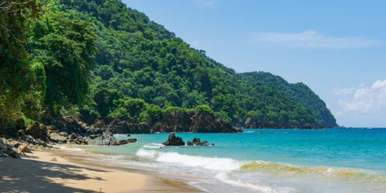 A stock photo shows a bay filled with Caribbean blue water on the island of Tobago.