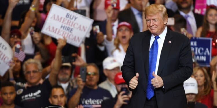 Then-President Donald Trump gives a thumbs up gesture as he takes the stage at a campaign rally in Las Vegas in 2018.