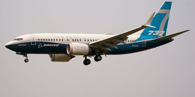 a Boeing 737 Max jet prepares to land at Boeing Field in Seattle