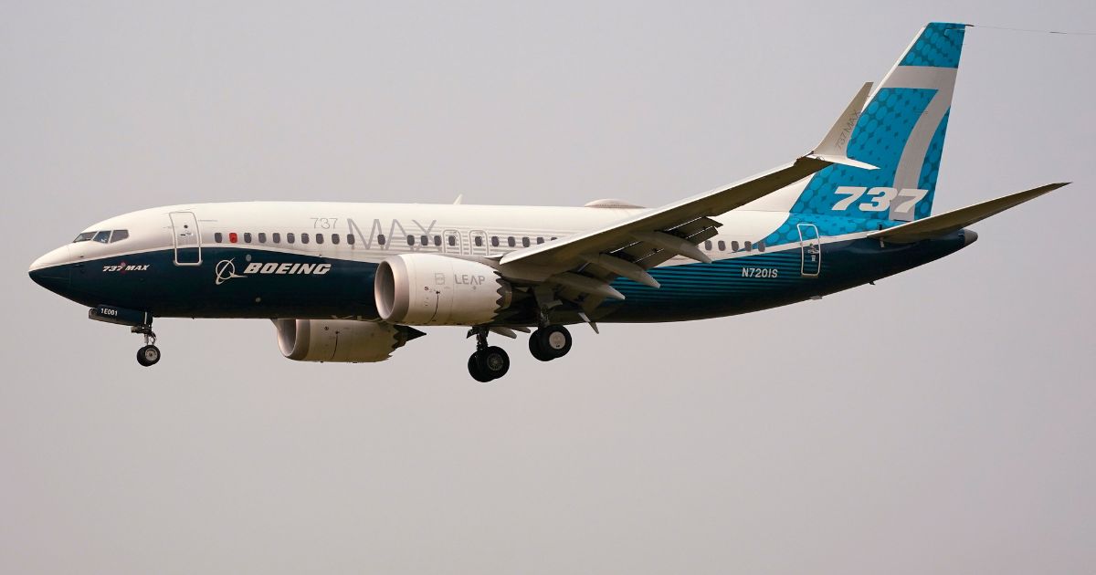 a Boeing 737 Max jet prepares to land at Boeing Field in Seattle