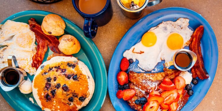 This Getty stock image shows an aerial view of two breakfast plates, and a cup of coffee.