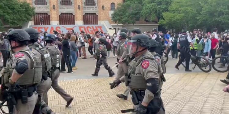 Law enforcement officers move in on protesters Wednesday at University of Texas in Austin.