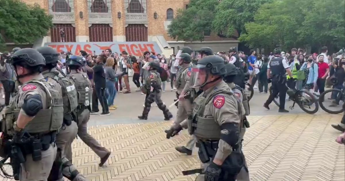 Law enforcement officers move in on protesters Wednesday at University of Texas in Austin.