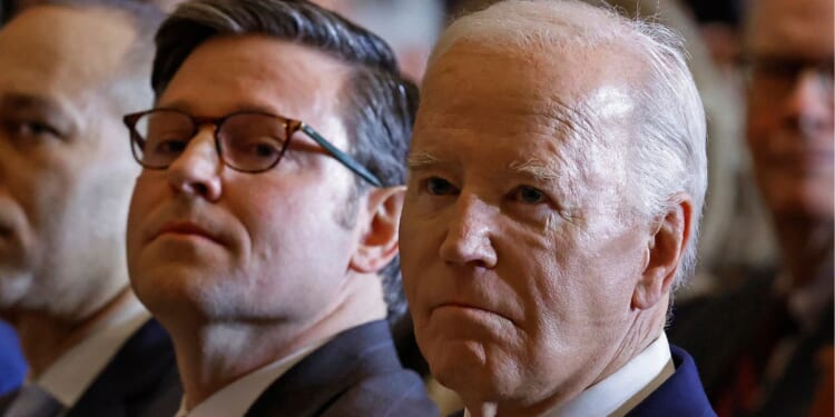 Speaker of the House Mike Johnson, left, and President Joe Biden, right, attend the annual National Prayer Breakfast in the U.S. Capitol in Washington, D.C., on Feb. 1.