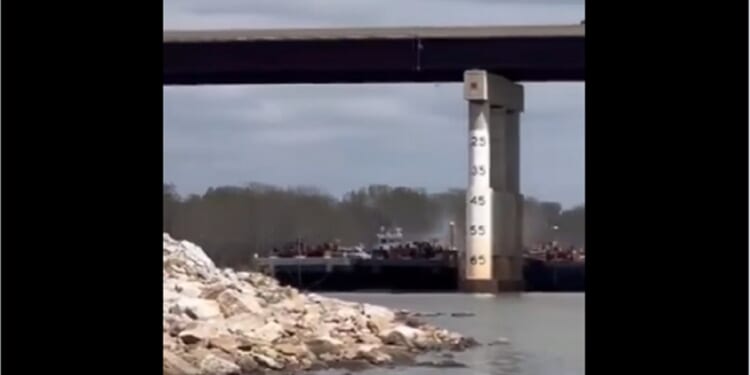 A barge strikes a bridge across the Arkansas River Saturday near Sallislaw, Oklahoma.