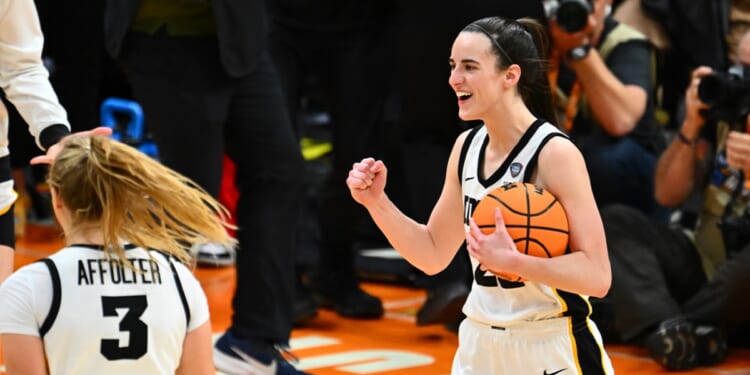 Caitlin Clark of the Iowa Hawkeyes pumps her fist after her team beating the University of Connecticut Huskies during the NCAA Women's Basketball Tournament Final Four semifinal game at Rocket Mortgage Fieldhouse on Friday in Cleveland.