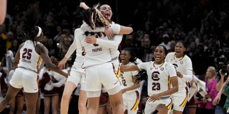 South Carolina players celebrate at the end of the Final Four college basketball championship game against Iowa in the women's NCAA Tournament, Sunday in Cleveland. South Carolina won 87-75.