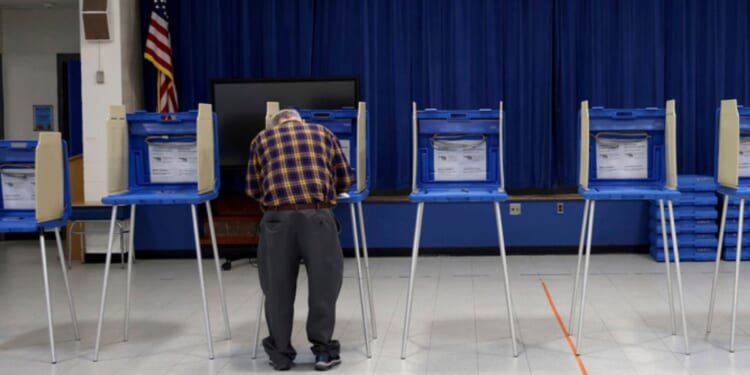 A voter casts his ballot at a polling station in Warwick, R.hode Island, during the state's primary election Tuesday.