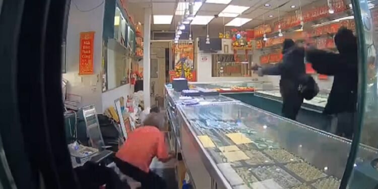 A still from security video captures a robbery in progress on Wednesday at an Oakland jewelry store.