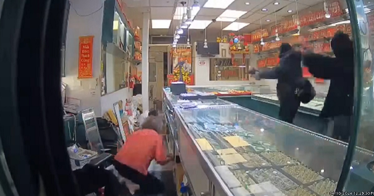 A still from security video captures a robbery in progress on Wednesday at an Oakland jewelry store.