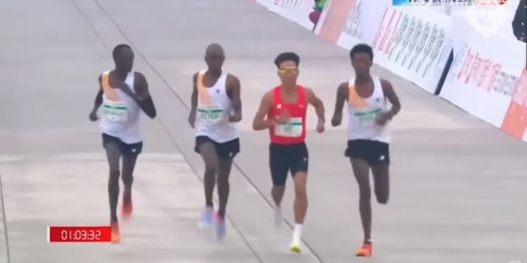 African runners appearing to slow down near the finish line to allow China's He Jie to overtake them