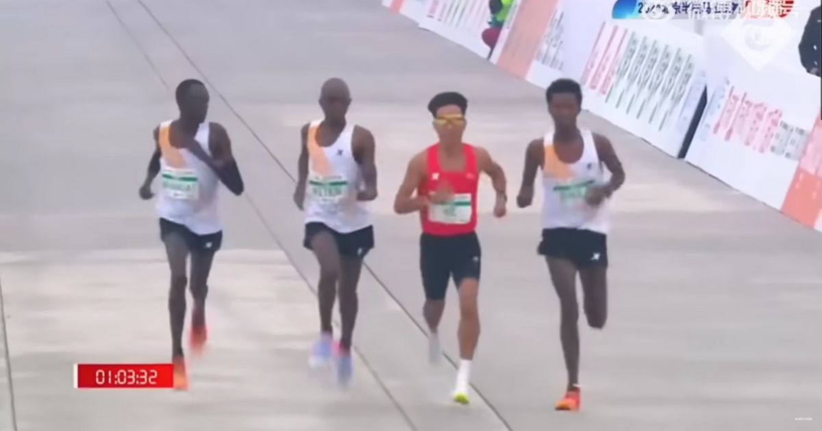 African runners appearing to slow down near the finish line to allow China's He Jie to overtake them