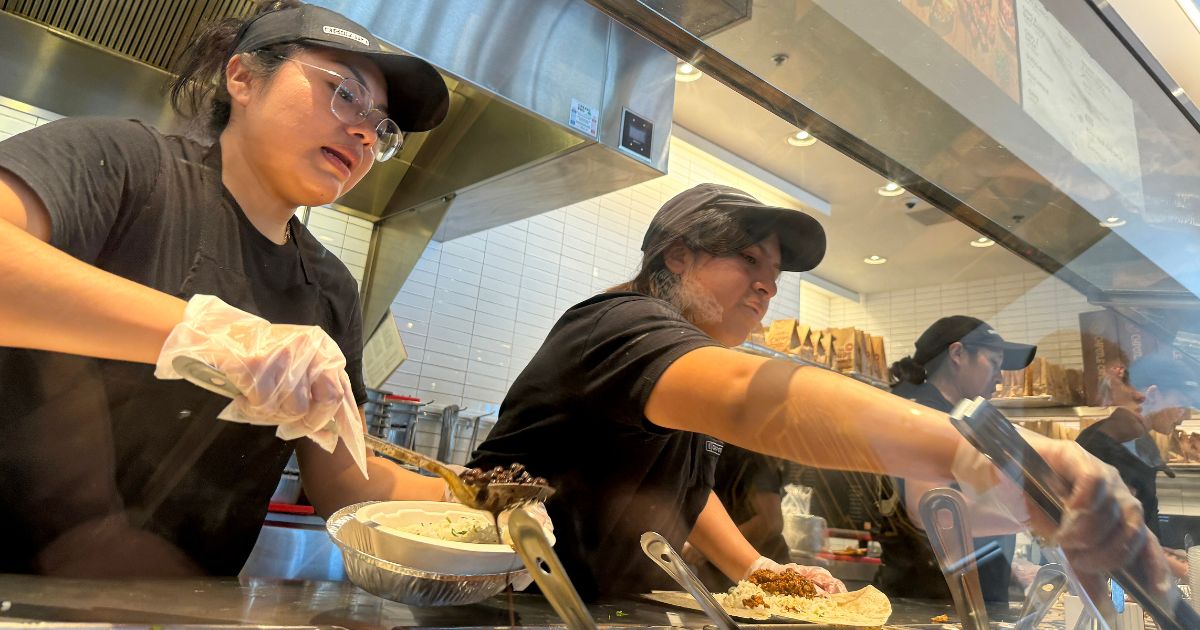 Workers fill food orders at a Chipotle restaurant in San Rafael, California, on April 1.