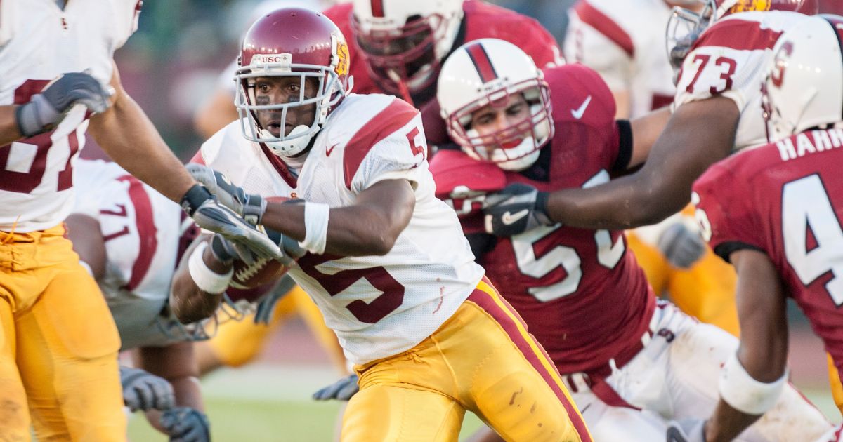 Reggie Bush #5 of the USC Trojans runs the ball during a Pac-10 NCAA football game against the Stanford Cardinals in Palo Alto, California, on Sept. 25, 2004.