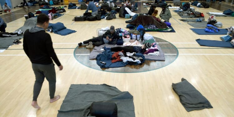 Illegal Immigrants rest at a makeshift shelter in Denver, Colorado, on Jan. 6, 2023.