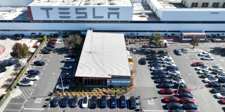 New Tesla cars sit in a parking lot at the Tesla factory in Fremont, California, on Oct. 19, 2022.