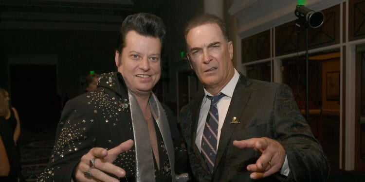 Elvis impersonator Brian Mills alongside actor Patrick Warburton at the wedding vow renewal ceremony for almost 300 different couples in Las Vegas, Nevada, in 2023.