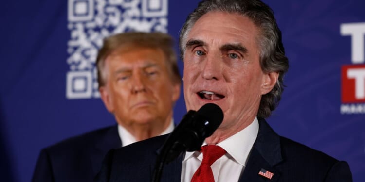 North Dakota Governor Doug Burgum encourages voters to support Republican presidential candidate and former President Donald Trump during a campaign rally in the basement ballroom of The Margate Resort on Jan. 22, 2024, in Laconia, New Hampshire. Burgum ran against Trump for the Republican presidential nomination but later dropped out and endorsed him.