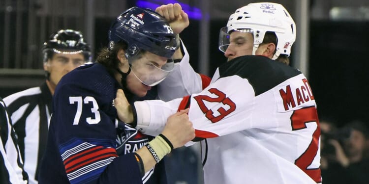 Kurtis MacDermid of the New Jersey Devils fights with Matt Rempe of the New York Rangers at the start of a game at Madison Square Garden in New York City on Wednesday.