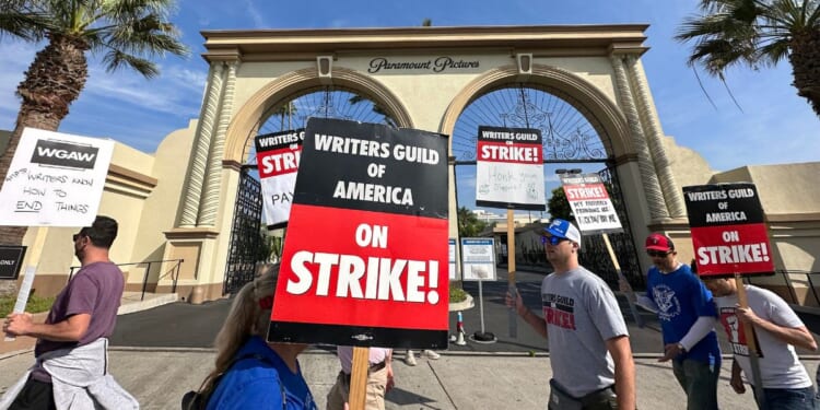 Picketers with the Writers Guild of America walk the line outside Paramount Studios in Los Angeles on Sept. 22.