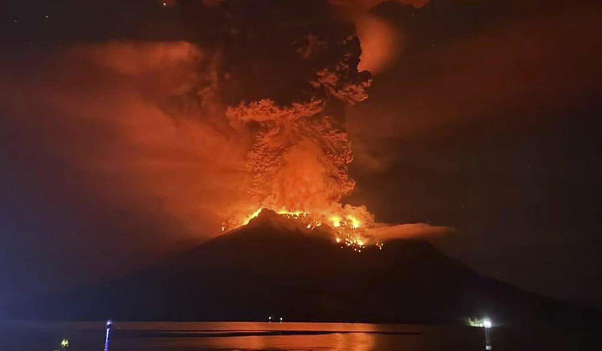 Indonesians evacuate from homes near erupting volcano and airport closes due to ash danger