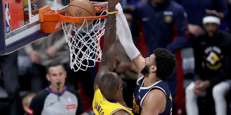 Jamal Murray of the Denver Nuggets dunks on LeBron James of the Los Angeles Lakers in the fourth quarter at Ball Arena in Denver on Monday night.