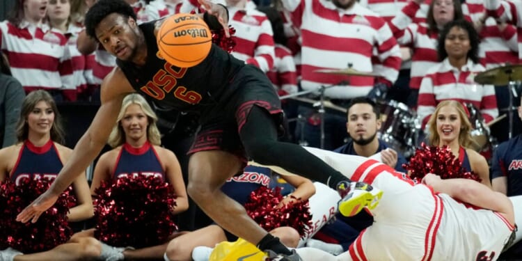 Southern California guard Bronny James, left, scrambles for the ball with Arizona guard Pelle Larsson during the first half of an NCAA college basketball game in the quarterfinal round of the Pac-12 tournament March 14, 2024, in Las Vegas.