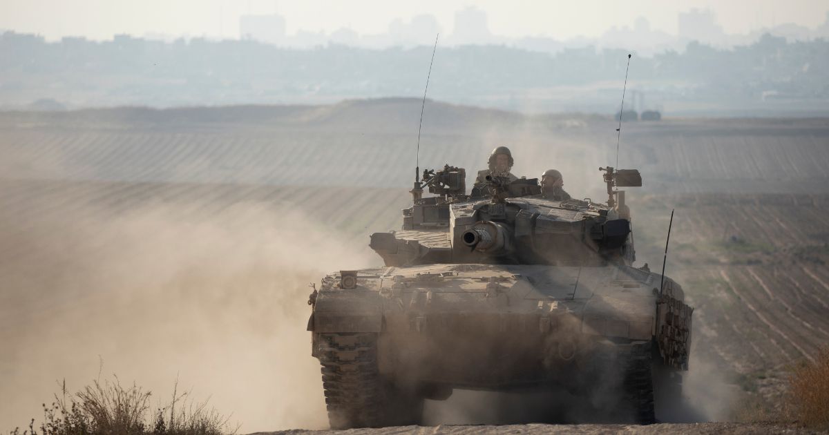 An Israeli tank moves along the border with the Gaza Strip on Sunday in southern Israel.