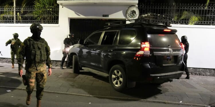 Police attempt to break into the Mexican embassy in Quito, Ecuador, on Friday.