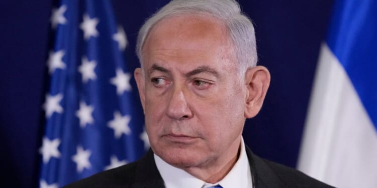 Israeli Prime Minister Benjamin Netanyahu looks on as the U.S. Secretary of State gives statements to the media in Tel Aviv, Israel, on Oct. 12.