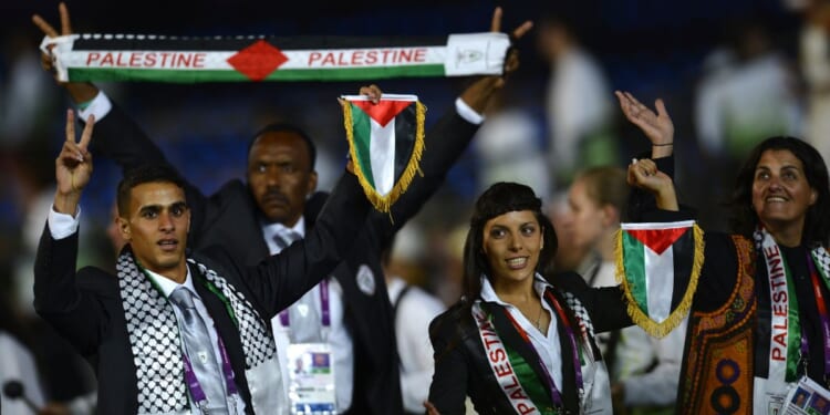 Members of the Palestinian delegation parade during the opening ceremony of the Summer Games at the Olympic Stadium in London on July 27, 2012.