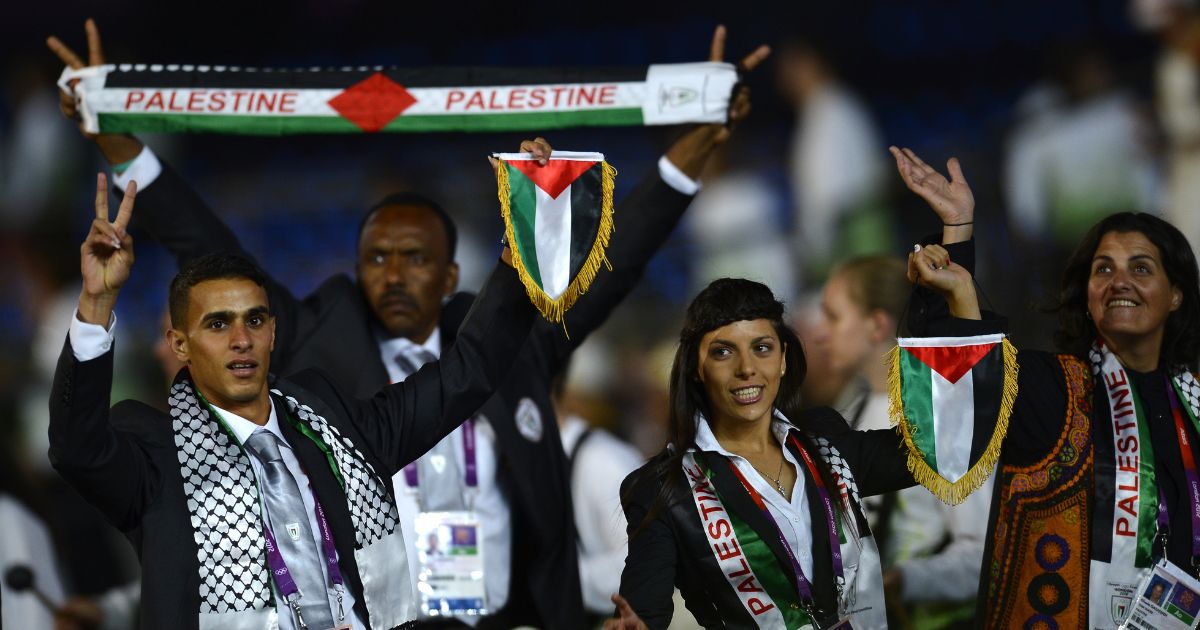 Members of the Palestinian delegation parade during the opening ceremony of the Summer Games at the Olympic Stadium in London on July 27, 2012.