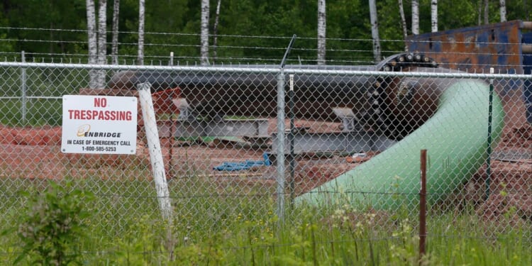 In this file photo from June 29, 2018, a No Trespassing sign is visible at a Enbridge Energy pipeline drilling pad in Minnesota. After President Joe Biden revoked Keystone XL's presidential permit and shut down construction of the long-disputed pipeline that was to carry oil from Canada to Texas, opponents of other pipelines hoped the projects they've been fighting would be next.