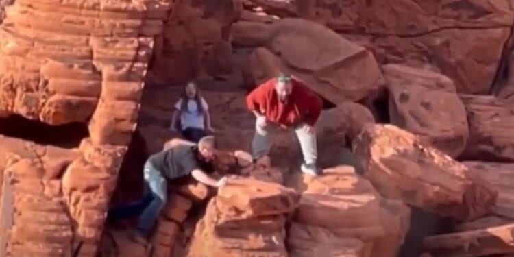 Two men destroy a protected rock formation in the Lake Mead Recreation Area.