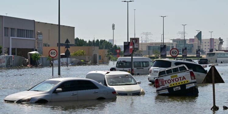 Cars are stranded on a flooded street in Dubai following heavy rains on Friday.