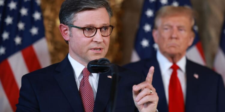 Republican presidential candidate former President Donald Trump listens as Speaker of the House Mike Johnson (R-LA) speaks during a press conference at Trump's Mar-a-Lago estate on April 12, in Palm Beach, Florida.