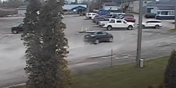 An SUV is seen racing toward a boat club in Michigan.