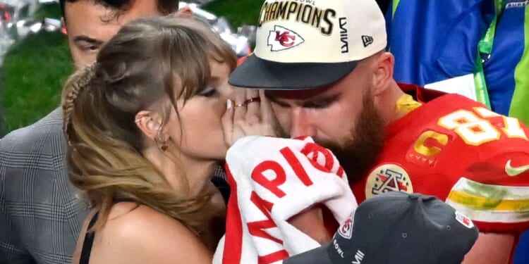 Pop star Taylor Swift, left, and Kansas City Chiefs tight end Travis Kelce, right, hare a moment after the NFL Super Bowl LVIII in Las Vegas, Nevada, on Feb. 11.