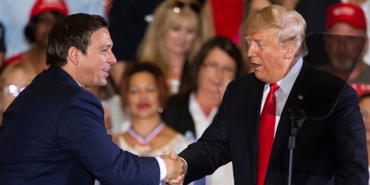 Donald Trump welcoming Ron DeSantis to the stage during a Florida rally in 2018